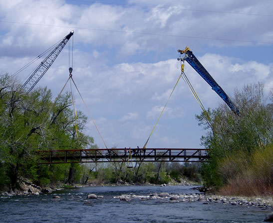 two cranes placing bridge
